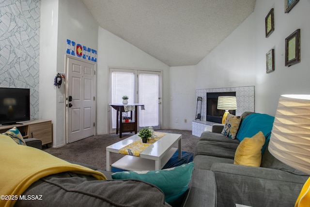 living room with a fireplace with raised hearth, carpet floors, high vaulted ceiling, and a textured ceiling