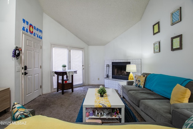 living area with a textured ceiling, high vaulted ceiling, carpet, and a premium fireplace