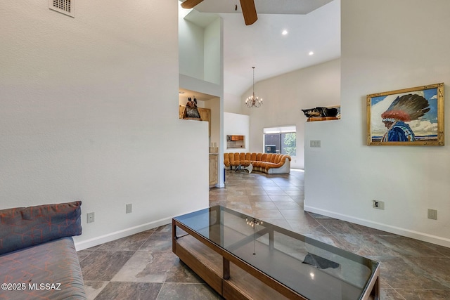 6091 N Golden Eagle Dr, Tucson, AZ 85750 - living room featuring baseboards, ceiling fan with notable chandelier, a high ceiling, and visible vents