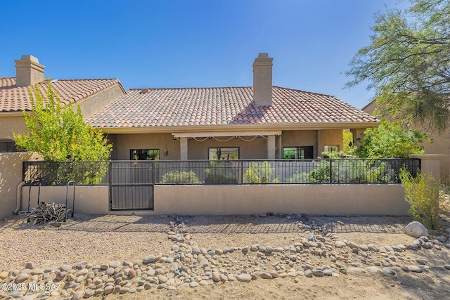 6091 N Golden Eagle Dr, Tucson, AZ 85750 - rear view of property featuring a chimney, fence, and a tile roof