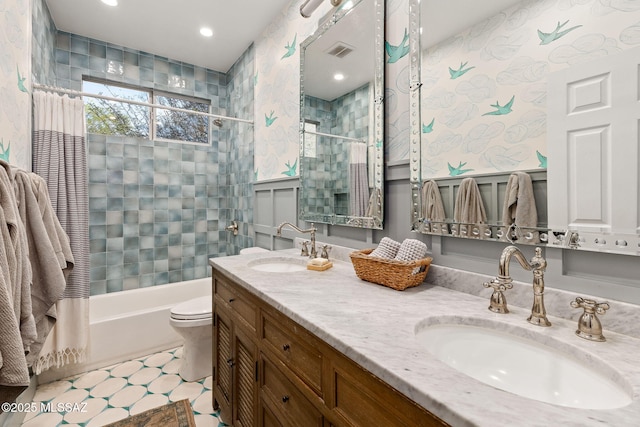 full bathroom with double vanity, visible vents, toilet, and a sink