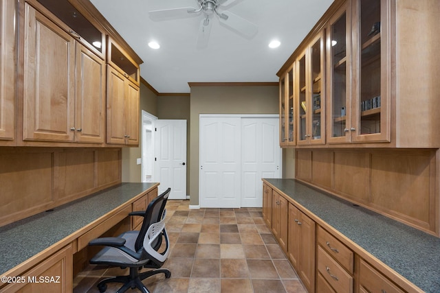 unfurnished office with built in desk, recessed lighting, a ceiling fan, and ornamental molding
