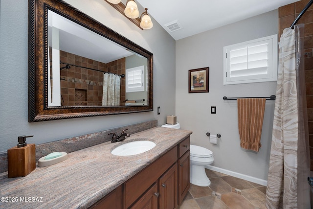 bathroom featuring vanity, tile patterned floors, toilet, visible vents, and baseboards