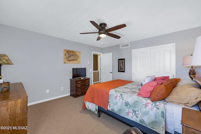 carpeted bedroom featuring visible vents, baseboards, a ceiling fan, and a closet
