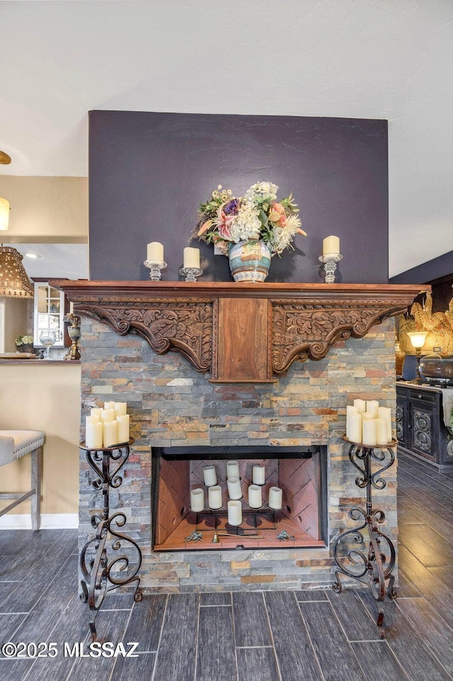 interior details featuring wood finish floors and a fireplace
