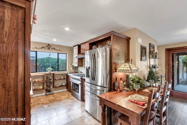 kitchen with open shelves, wall chimney exhaust hood, stainless steel appliances, decorative backsplash, and recessed lighting