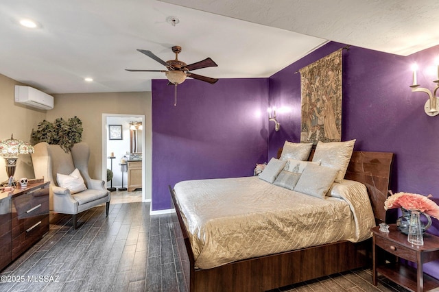 bedroom with a wall mounted air conditioner, baseboards, recessed lighting, and dark wood finished floors