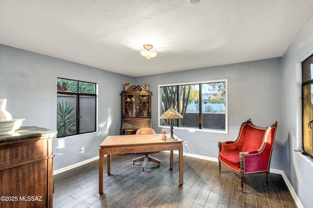 home office featuring baseboards, a wealth of natural light, and wood finished floors