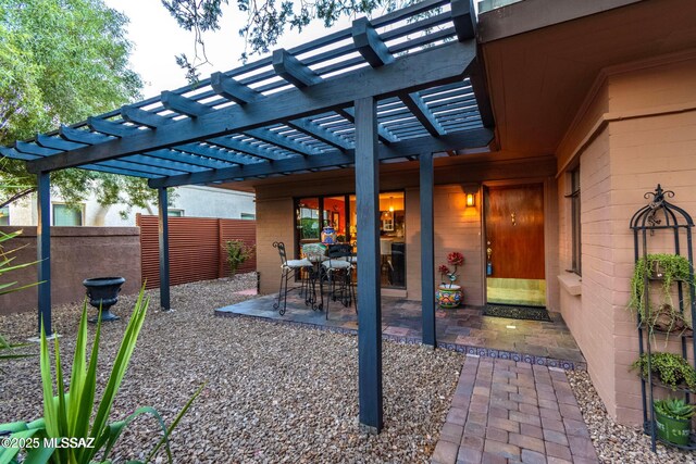 view of patio / terrace with fence, outdoor dining area, and a pergola
