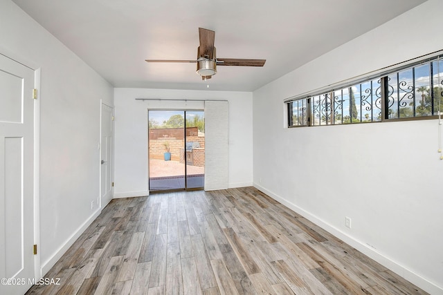 1838 N Campbell Ave, Tucson, AZ 85719 - empty room featuring a healthy amount of sunlight, ceiling fan, and wood finished floors