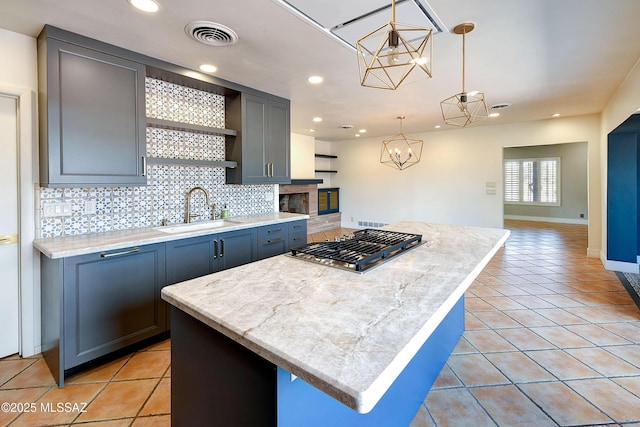 1838 N Campbell Ave, Tucson, AZ 85719 - kitchen featuring open shelves, a sink, light tile patterned flooring, stainless steel gas cooktop, and decorative backsplash