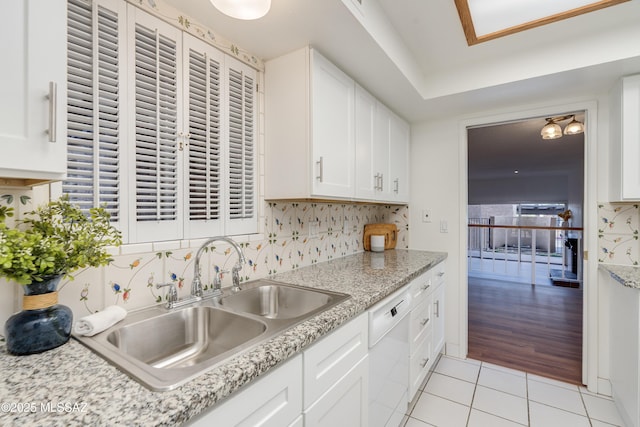 538 N Dodge Blvd, Tucson, AZ 85716 - kitchen with decorative backsplash, dishwasher, white cabinetry, a sink, and light tile patterned floors