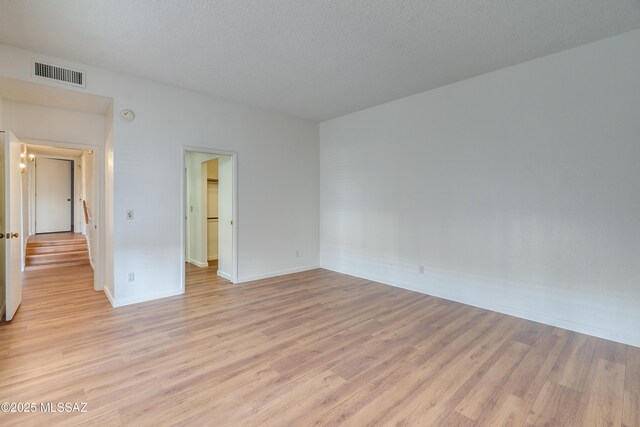538 N Dodge Blvd, Tucson, AZ 85716 - unfurnished room with baseboards, a textured ceiling, visible vents, and light wood finished floors