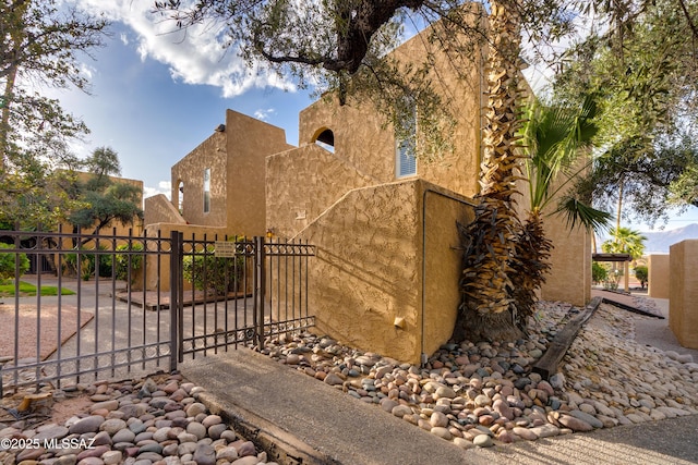 538 N Dodge Blvd, Tucson, AZ 85716 - view of home's exterior featuring a gate, fence, and stucco siding