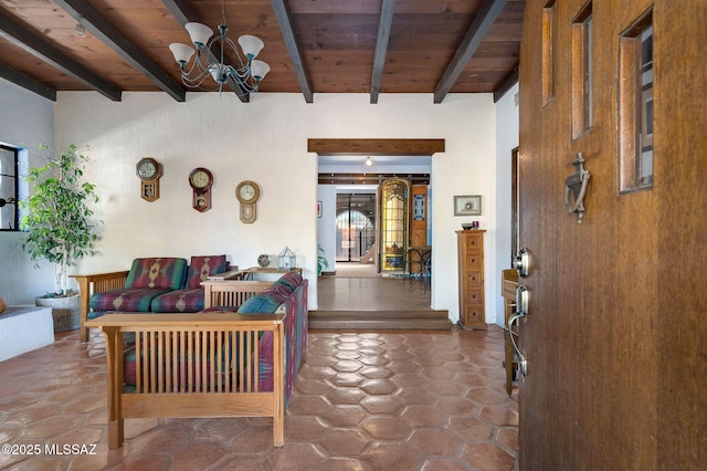 living room with beamed ceiling, wooden ceiling, and a chandelier