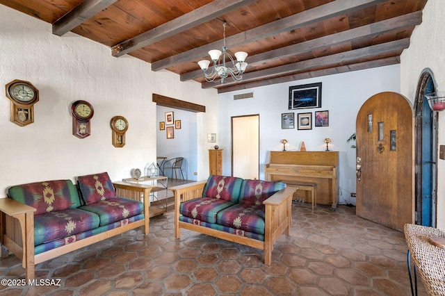 living area with visible vents, a notable chandelier, wooden ceiling, and beam ceiling