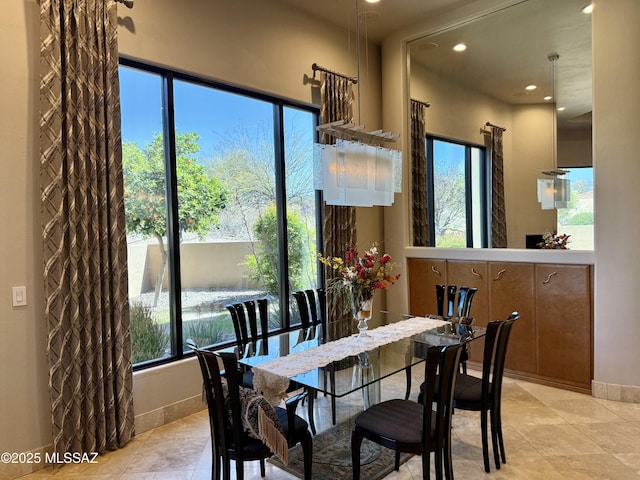 dining area featuring recessed lighting, light tile patterned floors, and a healthy amount of sunlight