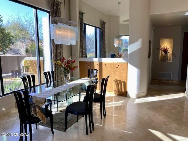 dining area with visible vents and light tile patterned floors