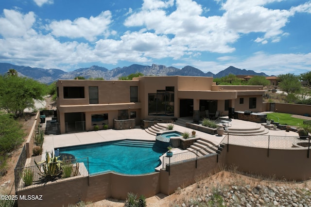 view of swimming pool with a patio area, a mountain view, and a fenced backyard