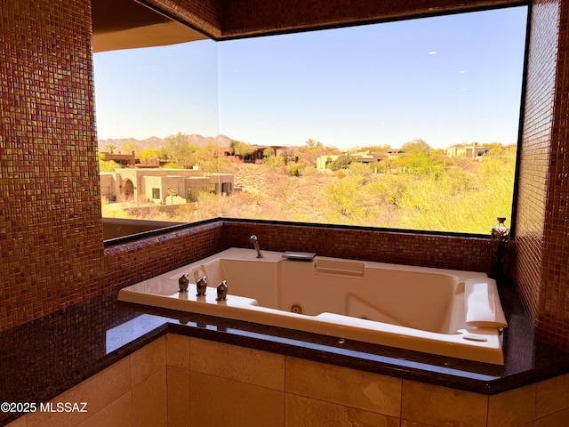 full bath featuring a tub with jets and a mountain view
