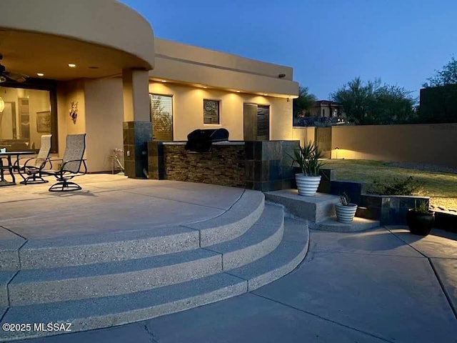 view of patio / terrace with fence, area for grilling, and ceiling fan
