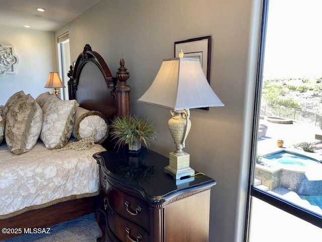 bedroom with wood finished floors and multiple windows