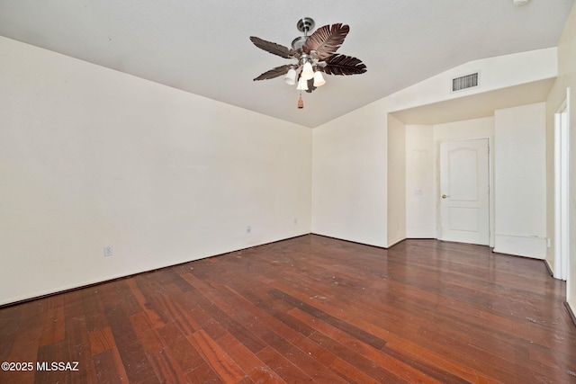 empty room with visible vents, lofted ceiling, ceiling fan, and wood-type flooring