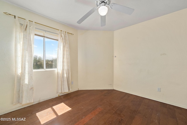 spare room with baseboards, ceiling fan, and wood-type flooring