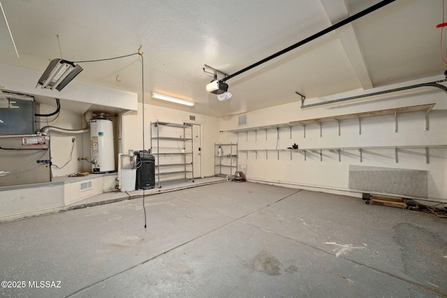 garage featuring water heater and a garage door opener