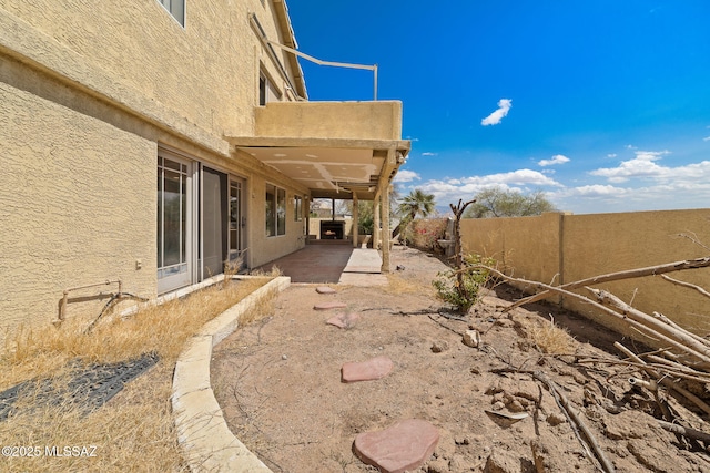 view of yard featuring fence and a patio area