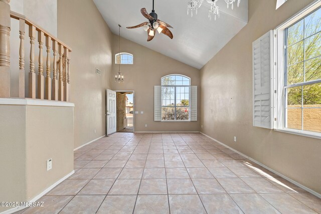 entrance foyer featuring a wealth of natural light, visible vents, tile patterned floors, and ceiling fan with notable chandelier