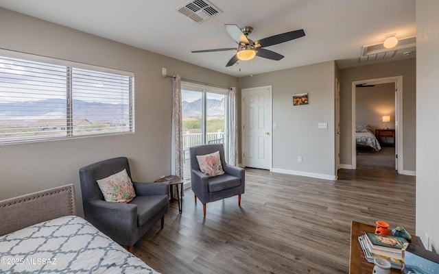 bedroom with access to exterior, baseboards, visible vents, and wood finished floors