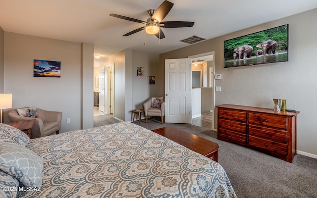 carpeted bedroom featuring ensuite bath, baseboards, ceiling fan, and visible vents