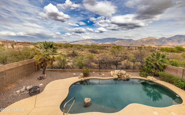 view of pool featuring a mountain view, a fenced backyard, and a fenced in pool