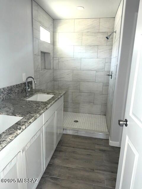 49 S Richmond Dr, Corona De Tucson, AZ 85641 - full bathroom with tiled shower, vanity, and wood finished floors