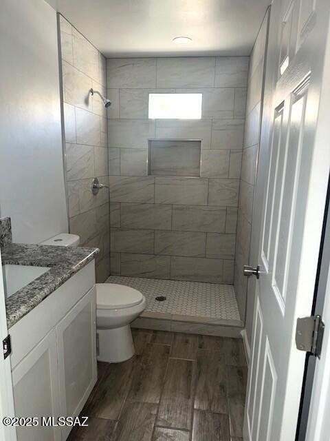 49 S Richmond Dr, Corona De Tucson, AZ 85641 - full bathroom with a shower stall, vanity, wood finish floors, and toilet