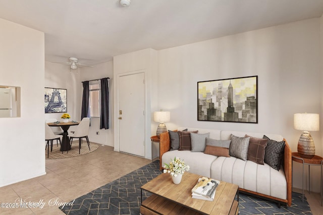 living room with ceiling fan and tile patterned flooring