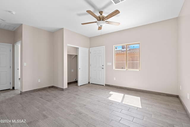 unfurnished bedroom featuring baseboards, light wood-style floors, and ceiling fan
