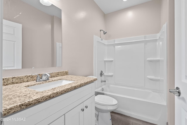 full bathroom featuring tub / shower combination, toilet, vanity, and wood finished floors