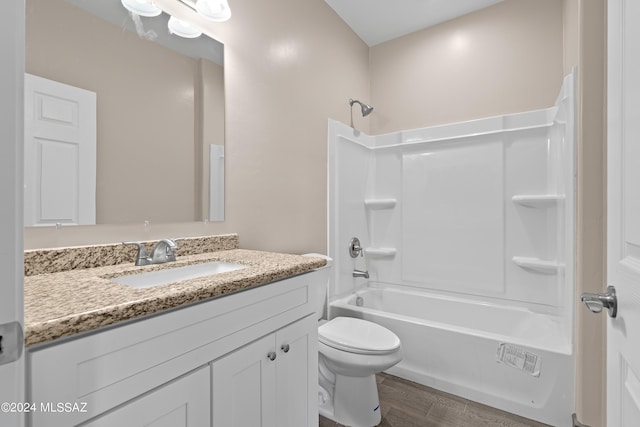 bathroom featuring bathtub / shower combination, wood finished floors, toilet, and vanity