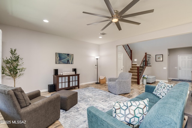 living room with a ceiling fan, baseboards, recessed lighting, and stairway