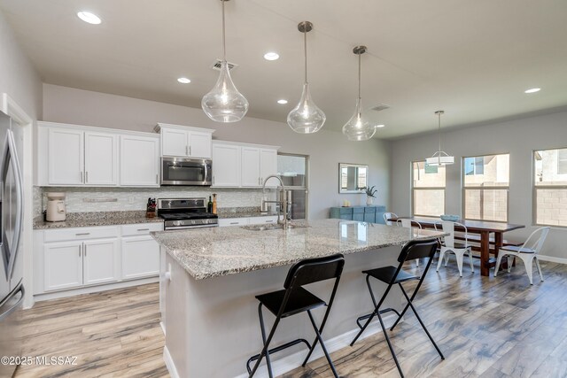 kitchen featuring a sink, decorative backsplash, stainless steel appliances, and recessed lighting
