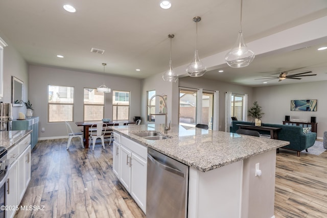 kitchen with a sink, recessed lighting, white cabinetry, stainless steel dishwasher, and visible vents