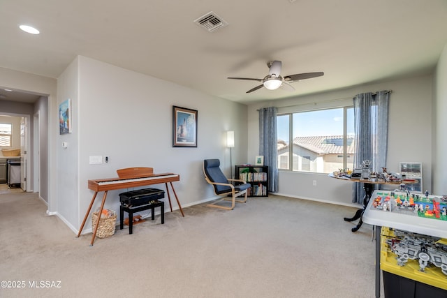 living area featuring carpet floors, plenty of natural light, and ceiling fan