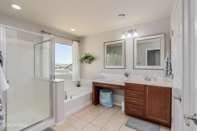 bathroom with tile patterned flooring, vanity, a shower stall, visible vents, and a bath
