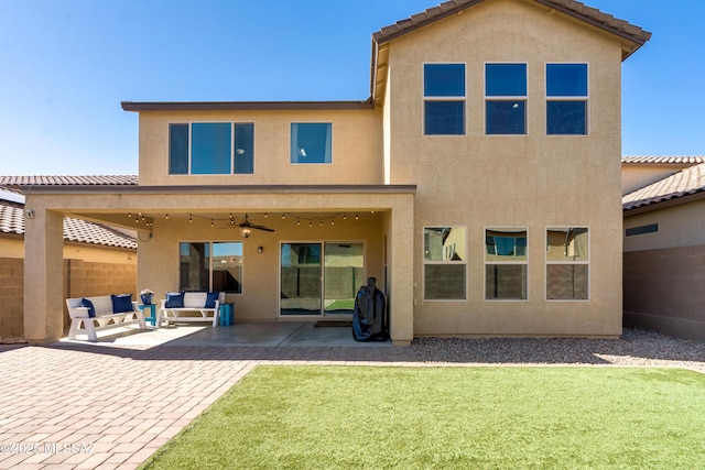 back of house featuring a ceiling fan, a patio area, and stucco siding
