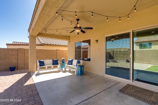 view of patio with fence, a ceiling fan, and an outdoor living space