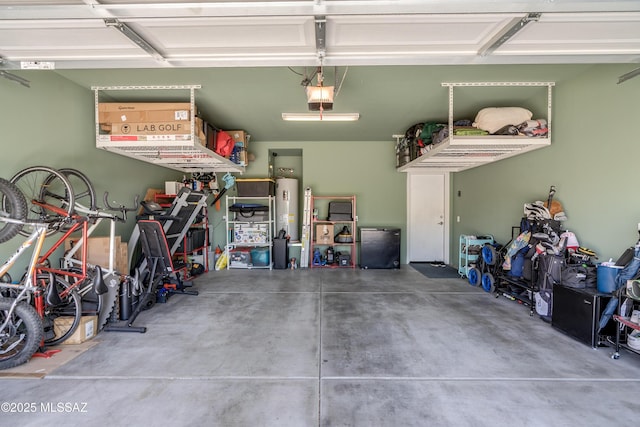 garage featuring fridge, a garage door opener, and water heater