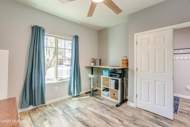 office area featuring baseboards, ceiling fan, and wood finished floors