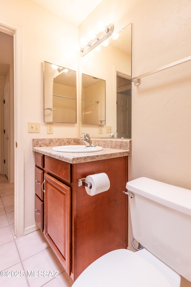 bathroom featuring tile patterned floors, toilet, and vanity